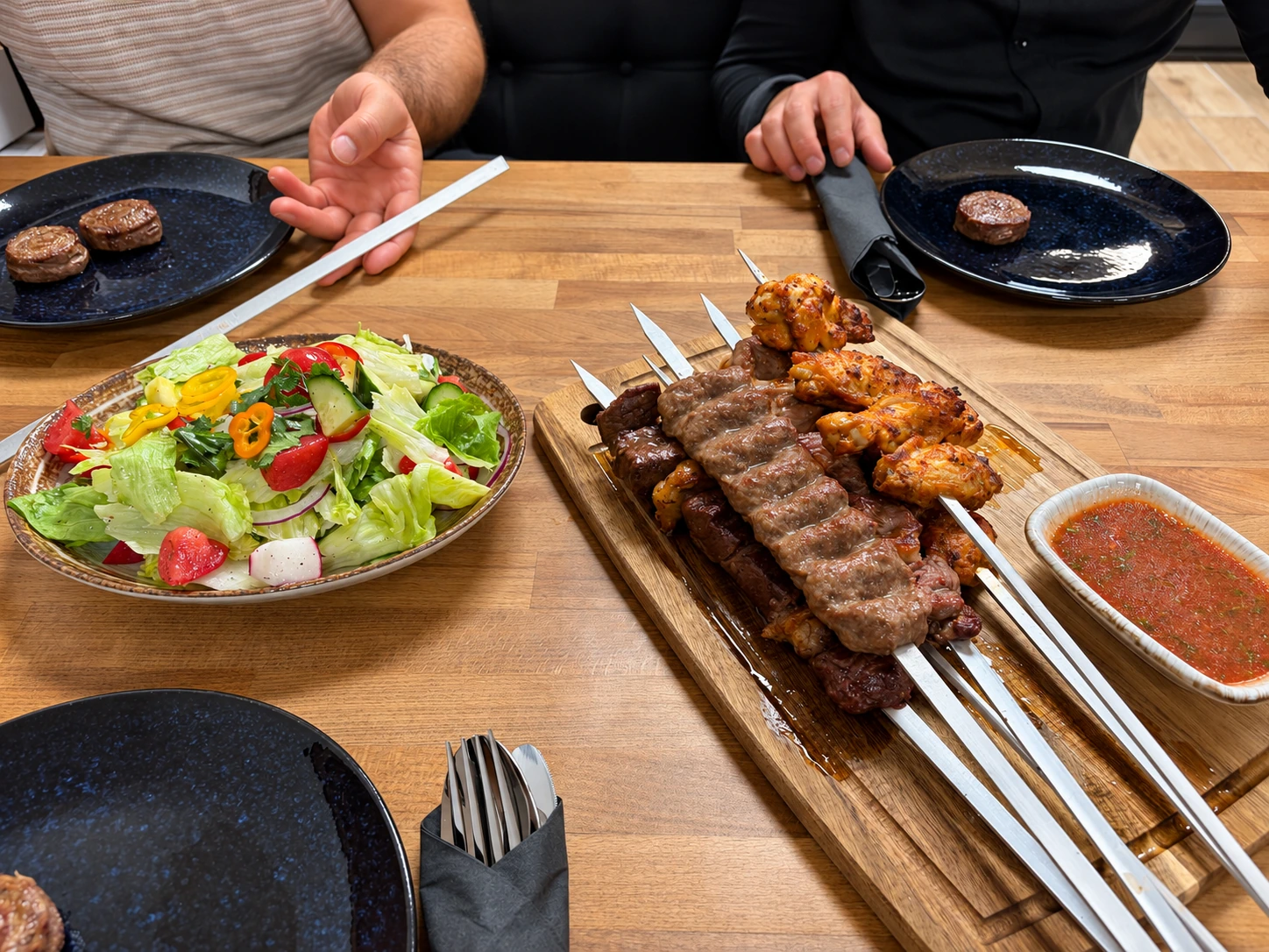 Butcher-Chef’s grilled meat and chicken skewers, salad and sauce, shared around the table