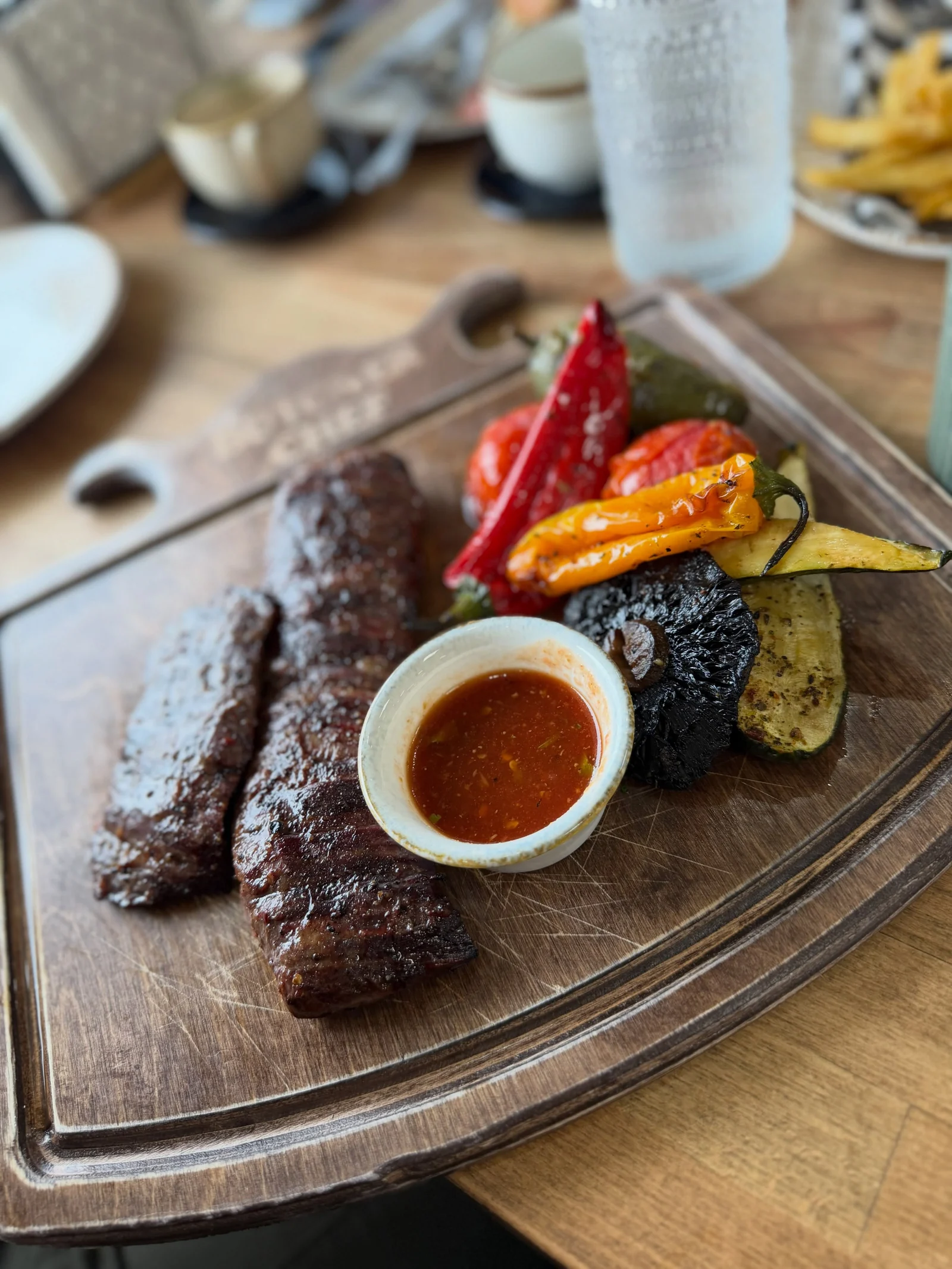 A seared steak with peppers, courgettes and sauce at Butcher Chef