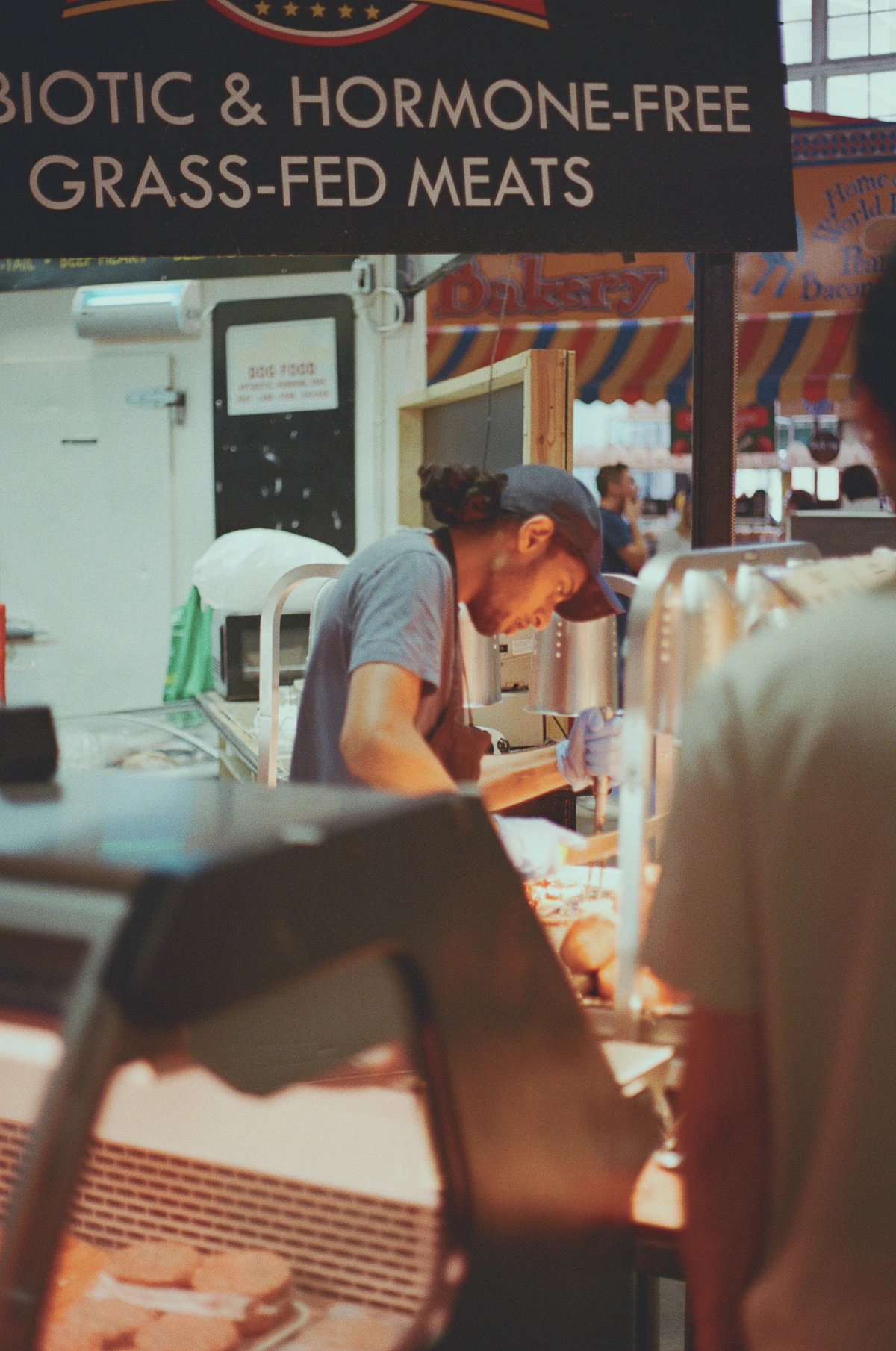 Butcher cutting fresh halal meat at the counter
